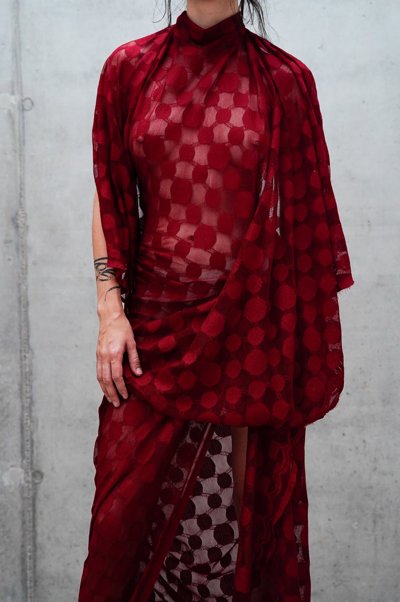 Red sheer check gown, draped at the hip with a pooled train