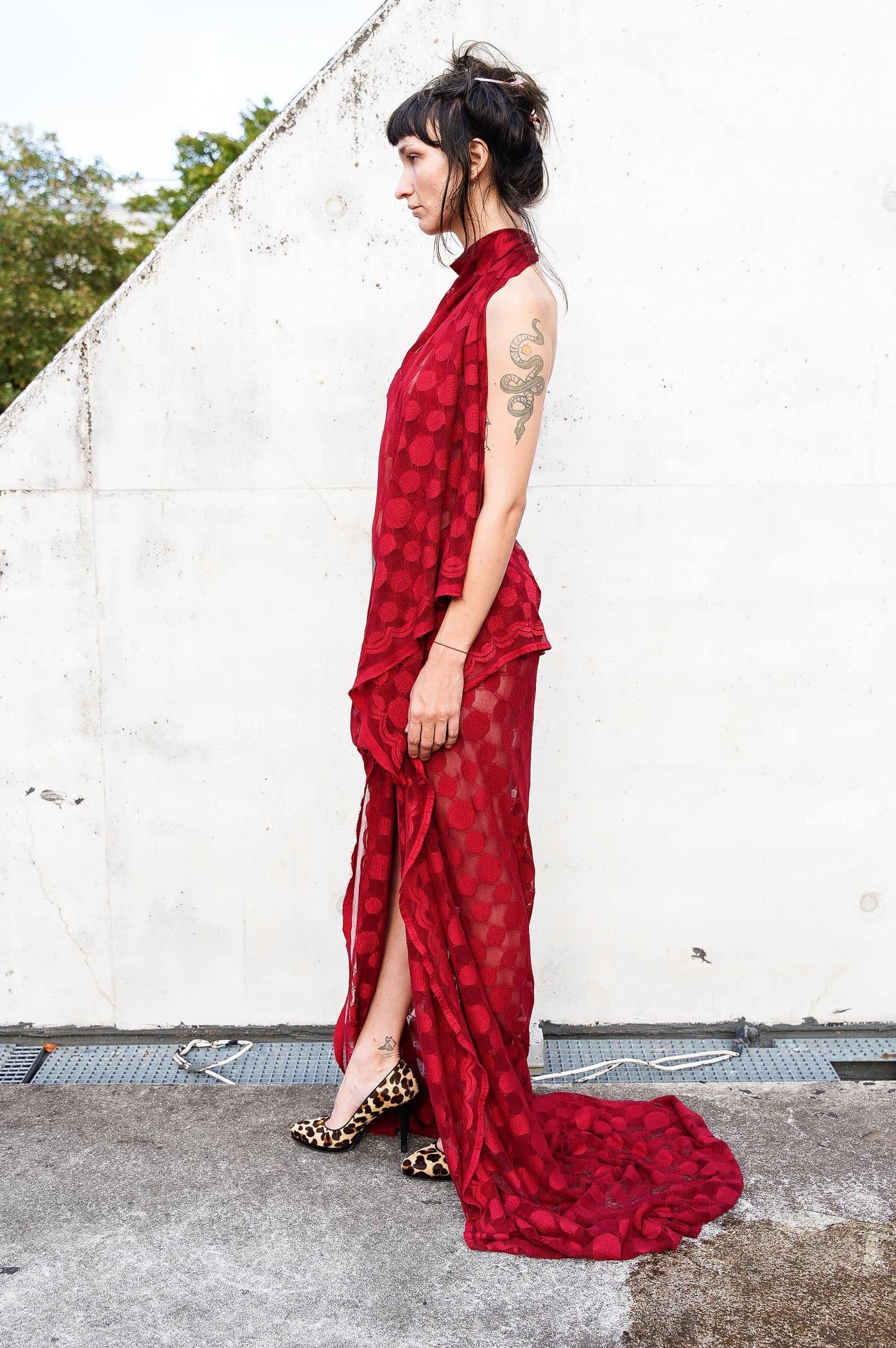 Red sheer check gown, draped at the hip with a pooled train